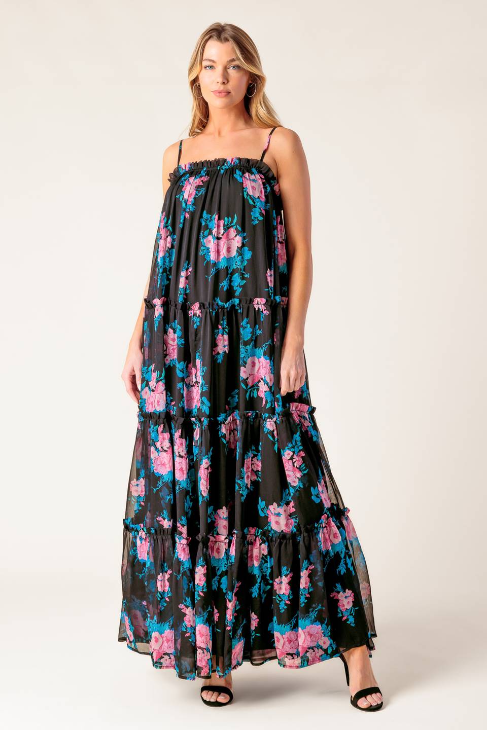 A printed woven maxi dress featuring straight neckline with ruffled edge, straps and tiered body