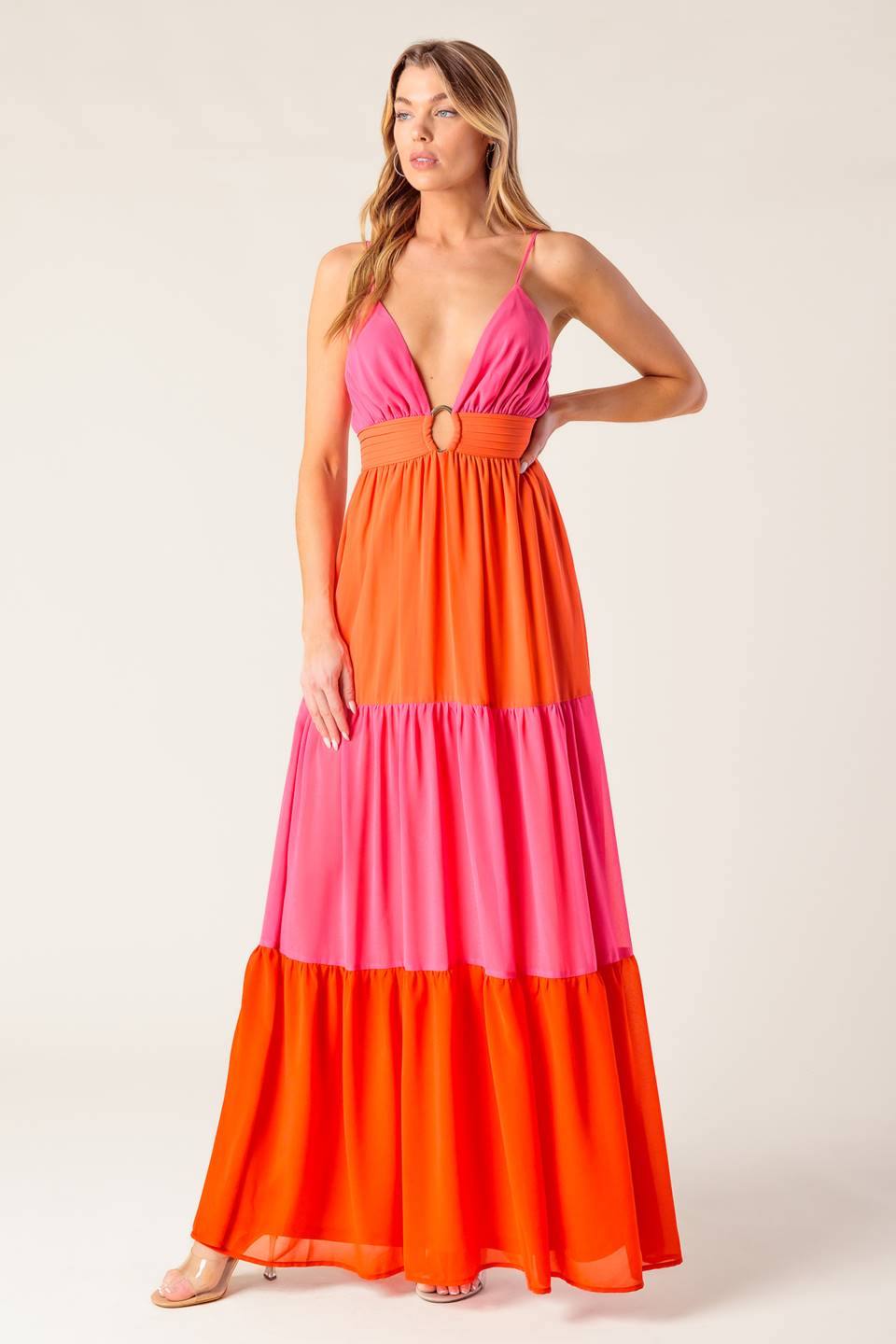 A solid woven color blocked maxi dress featuring cami top with straps, shirred waist band with center hardware, tiered skirt and smocked back waistband