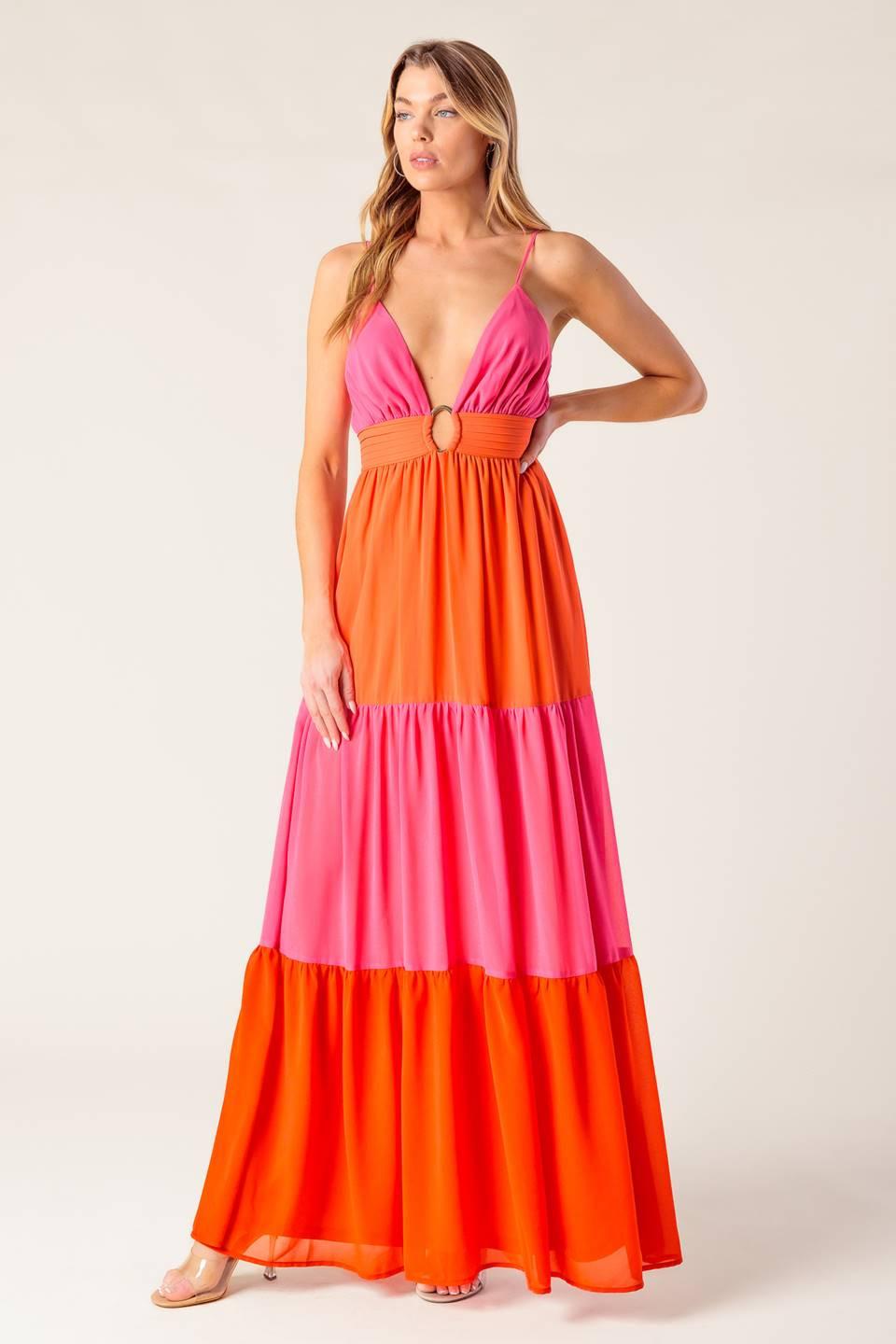 A solid woven color blocked maxi dress featuring cami top with straps, shirred waist band with center hardware, tiered skirt and smocked back waistband