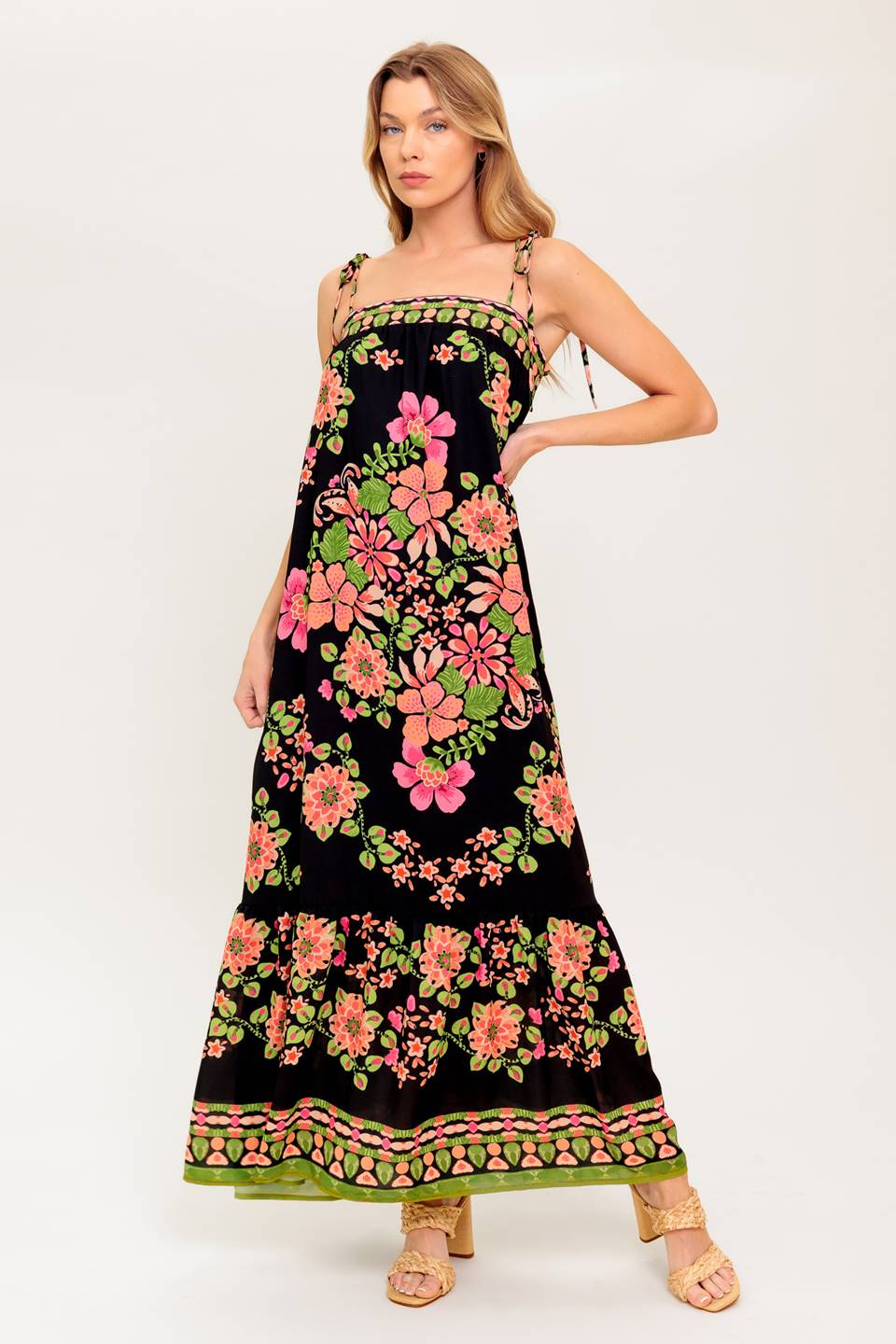 A printed woven maxi dress featuring straight neckline, shoulder tie and ruffled hem