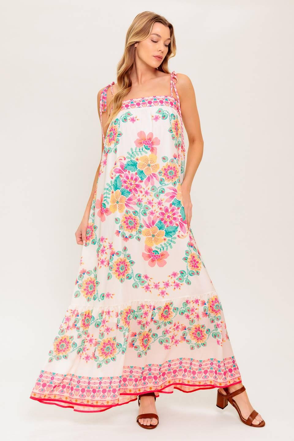 A printed woven maxi dress featuring straight neckline, shoulder tie and ruffled hem