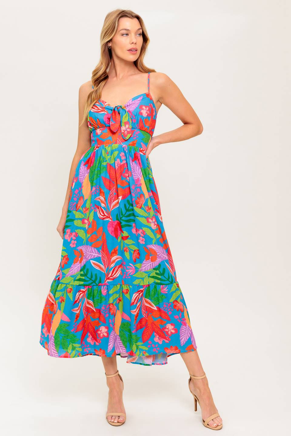 A printed woven dress featuring cami bodice with front tie detail, straps, ruffled hem and smocked back waist band