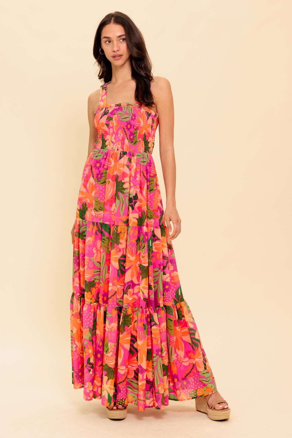 A printed woven maxi dress featuring smocked bodice, halter tie, tiered skirt, bare back with tie