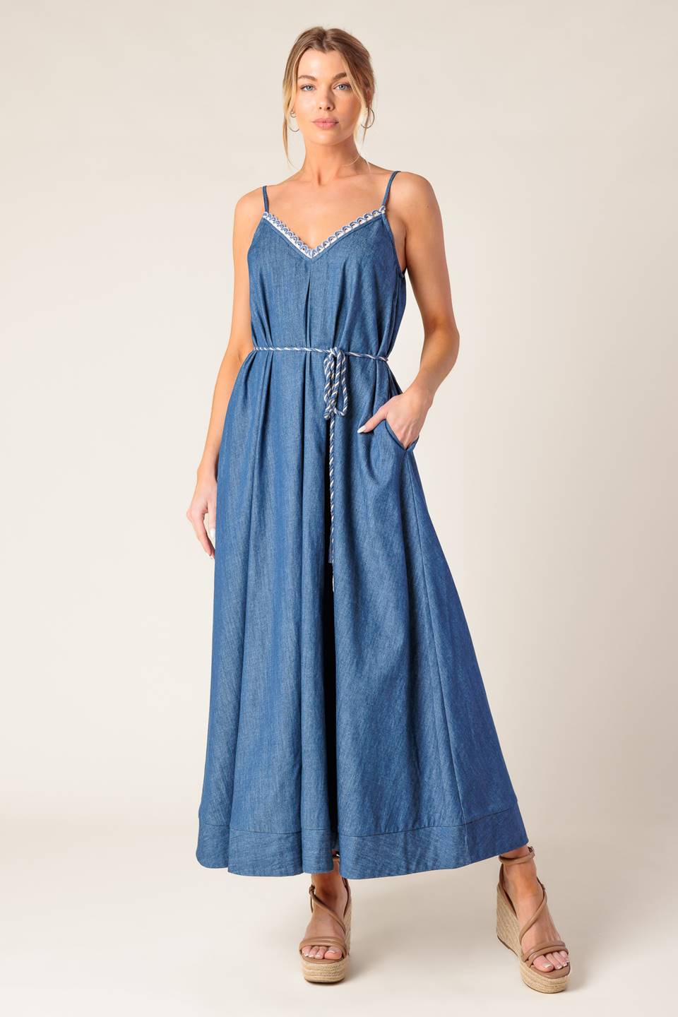 A washed denim midi dress featuring V neckline with lace edge, strap and rope belt