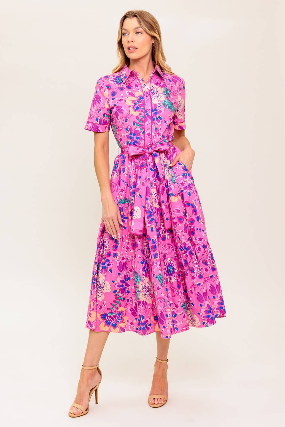 A printed woven midi dress featuring collar, button down, self sash tie, short sleeve and elasticized back waist