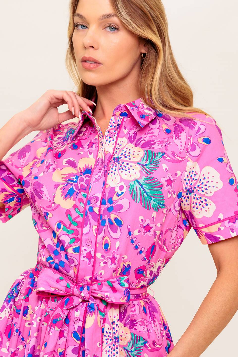 A printed woven midi dress featuring collar, button down, self sash tie, short sleeve and elasticized back waist