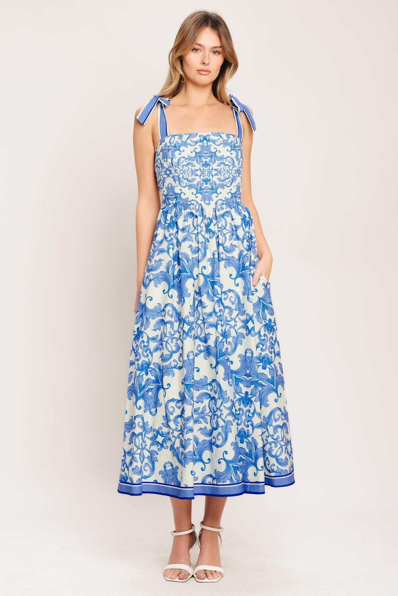 A printed woven midi dress featuring straight neckline, shoulder ties, full skirt and smocked back bodice
Details:
Self: 100% Cotton
Lining: 100% Polyester
Size & Fit
-Model is 5`8" And Wearing Size Small
-Measurements Taken From Size Small
-Approx. Length: 52"