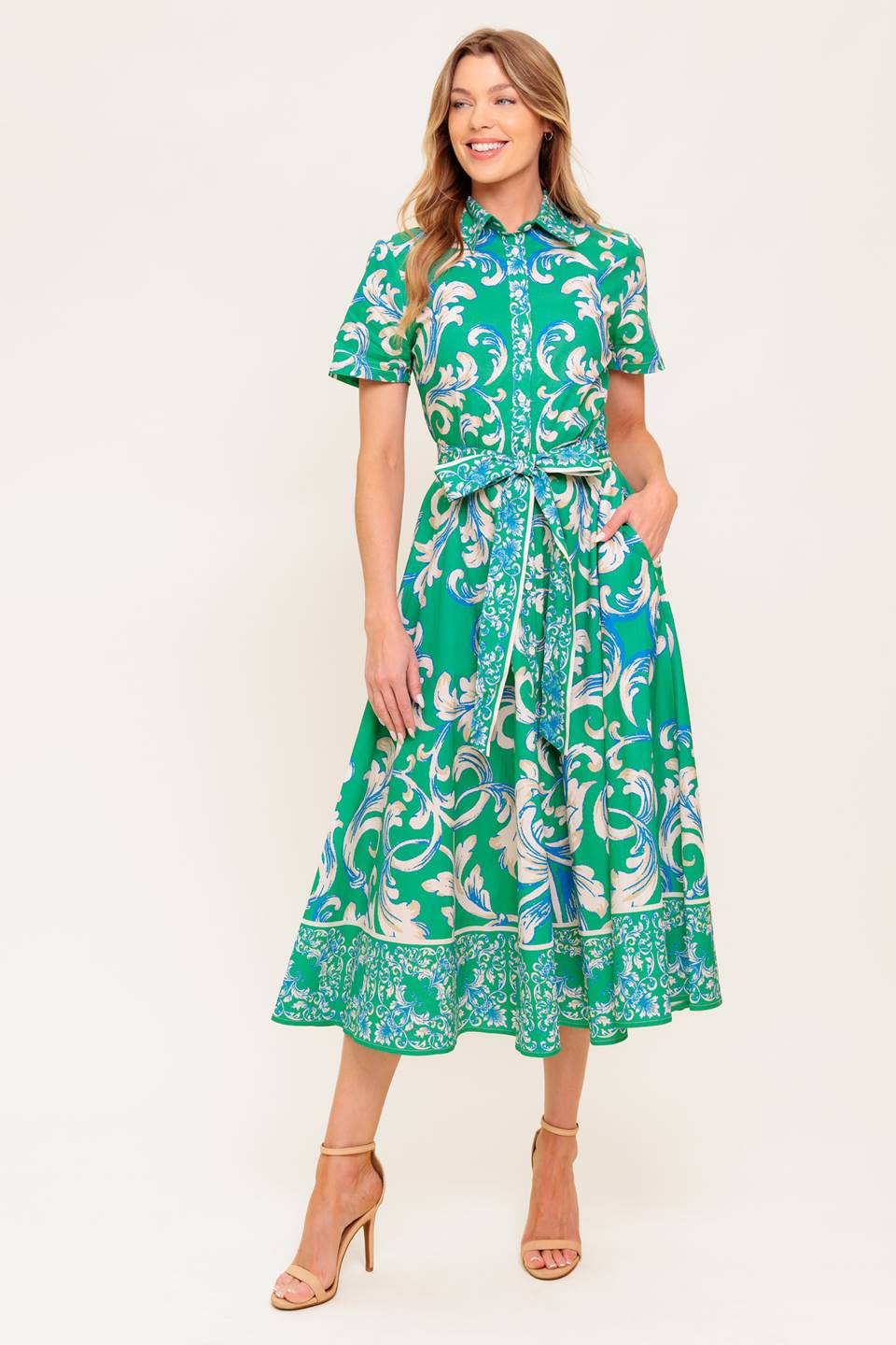 A printed woven midi dress featuring collar, short sleeve, button down, self sash tie and full skirt.
