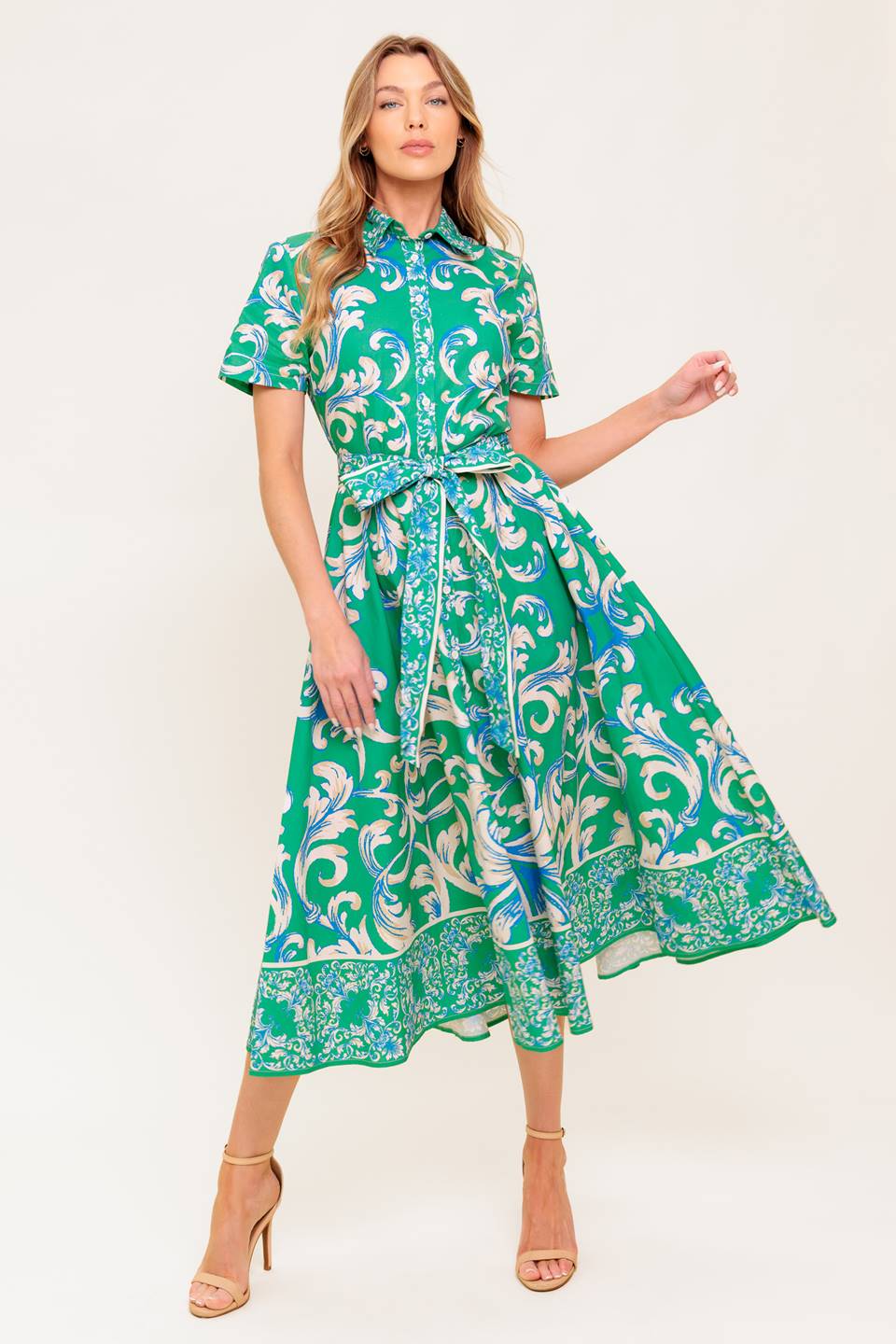 A printed woven midi dress featuring collar, short sleeve, button down, self sash tie and full skirt.