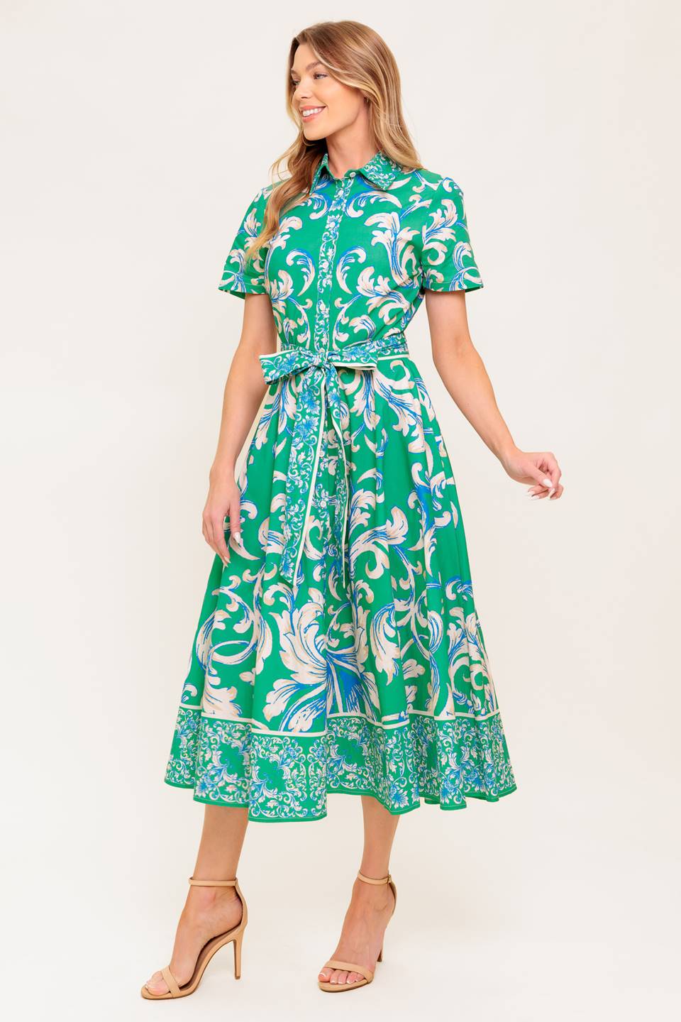 A printed woven midi dress featuring collar, short sleeve, button down, self sash tie and full skirt.