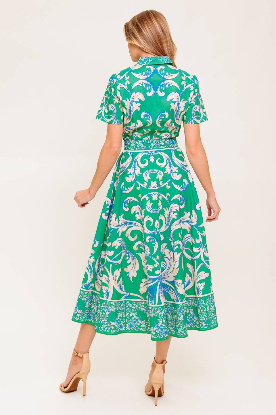 A printed woven midi dress featuring collar, short sleeve, button down, self sash tie and full skirt.