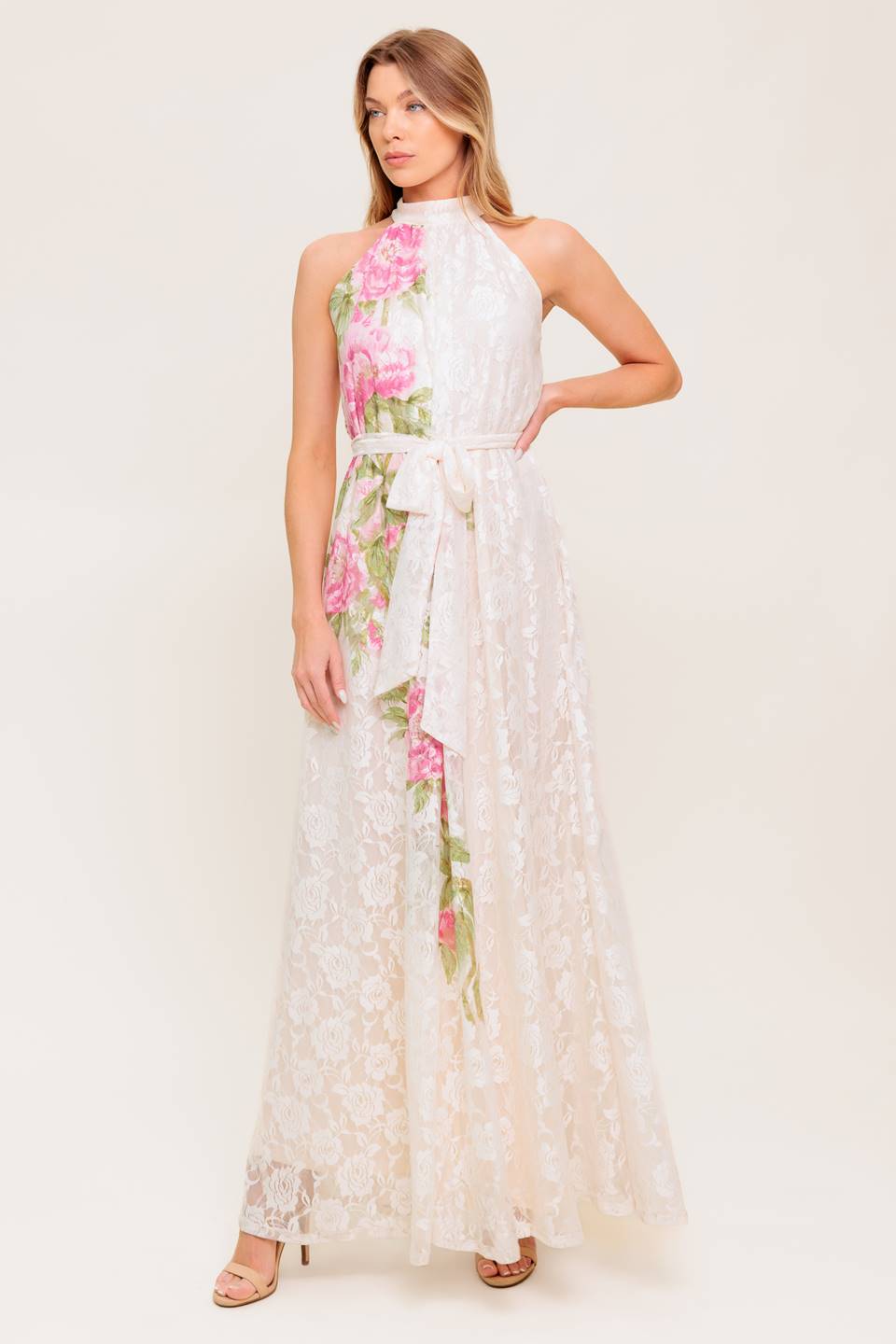 A printed woven lace maxi dress featuring halter neckline, self sash tie and back button closure.