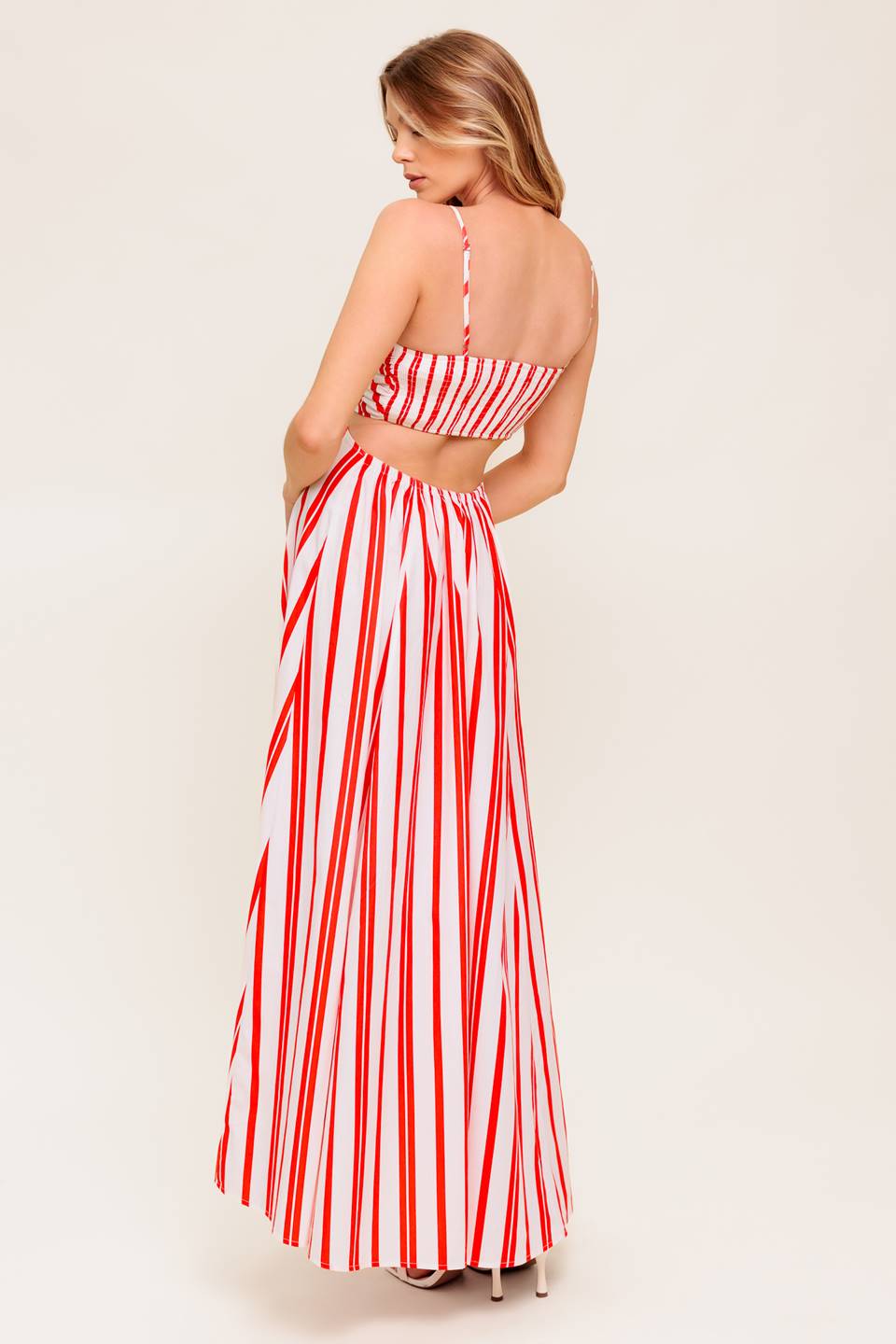A striped woven ankle dress featuring cami top with center O ring, wide skirt and smocked back bodice.