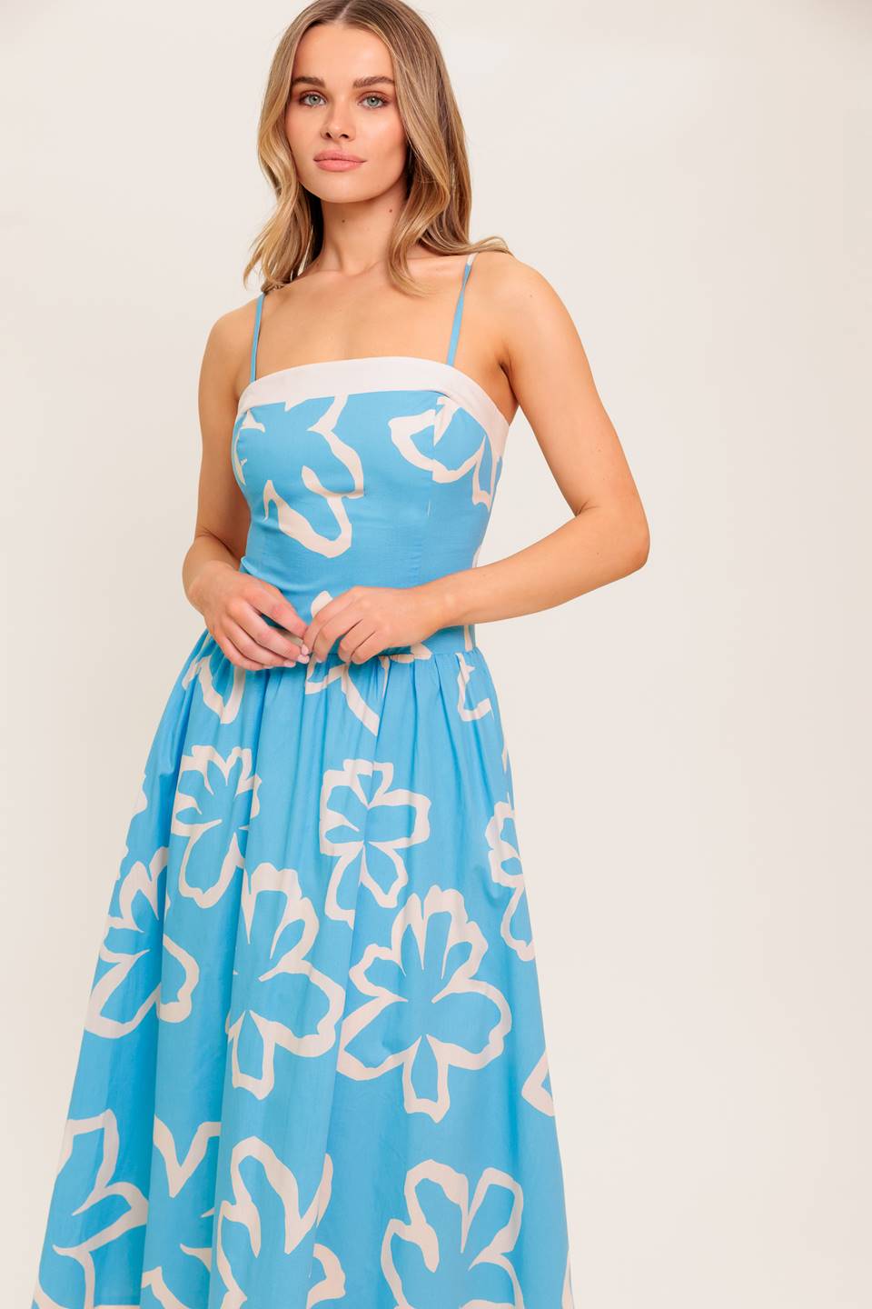 A printed woven midi dress featuring straight neckline, contrasting border and smocked back bodice.