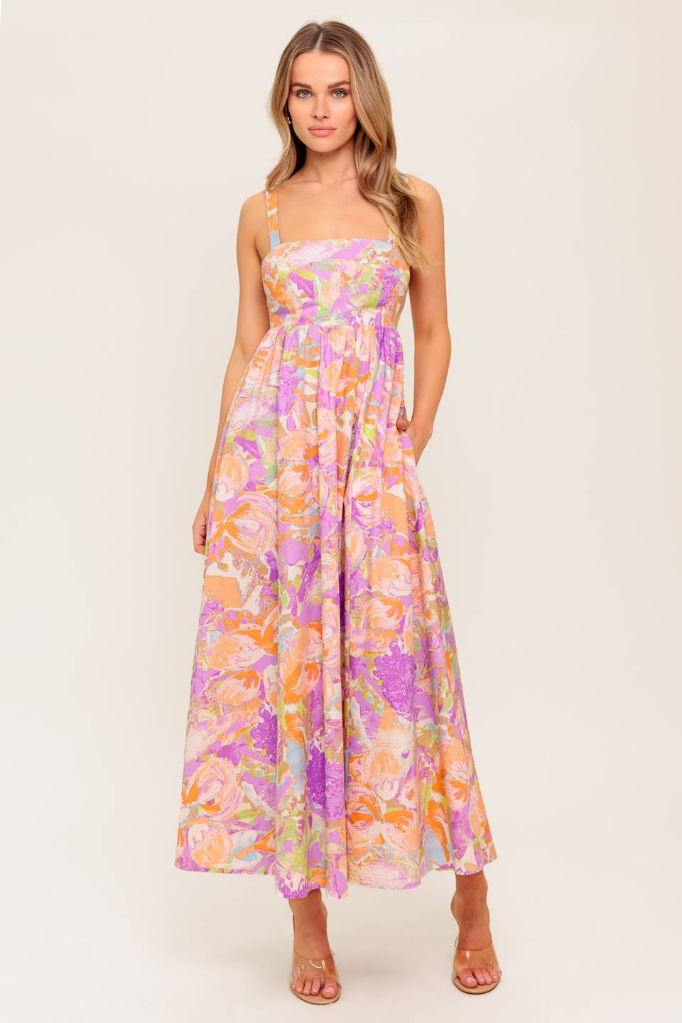 A printed woven midi dress featuring straight neckline, straps, full skirt, bare back with tie closure.