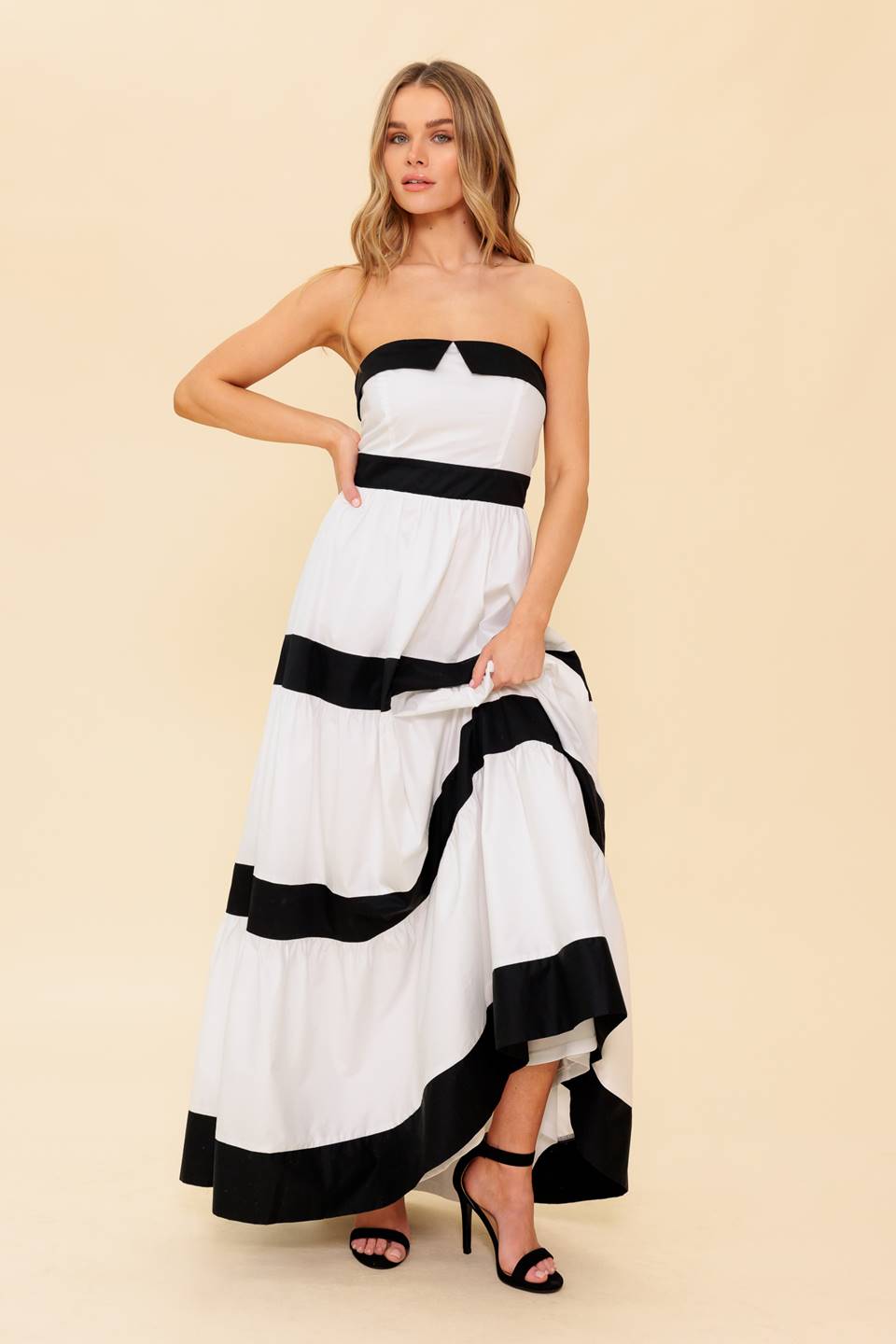 A solid color blocked maxi dress featuring tiered skirt and back zipper closure