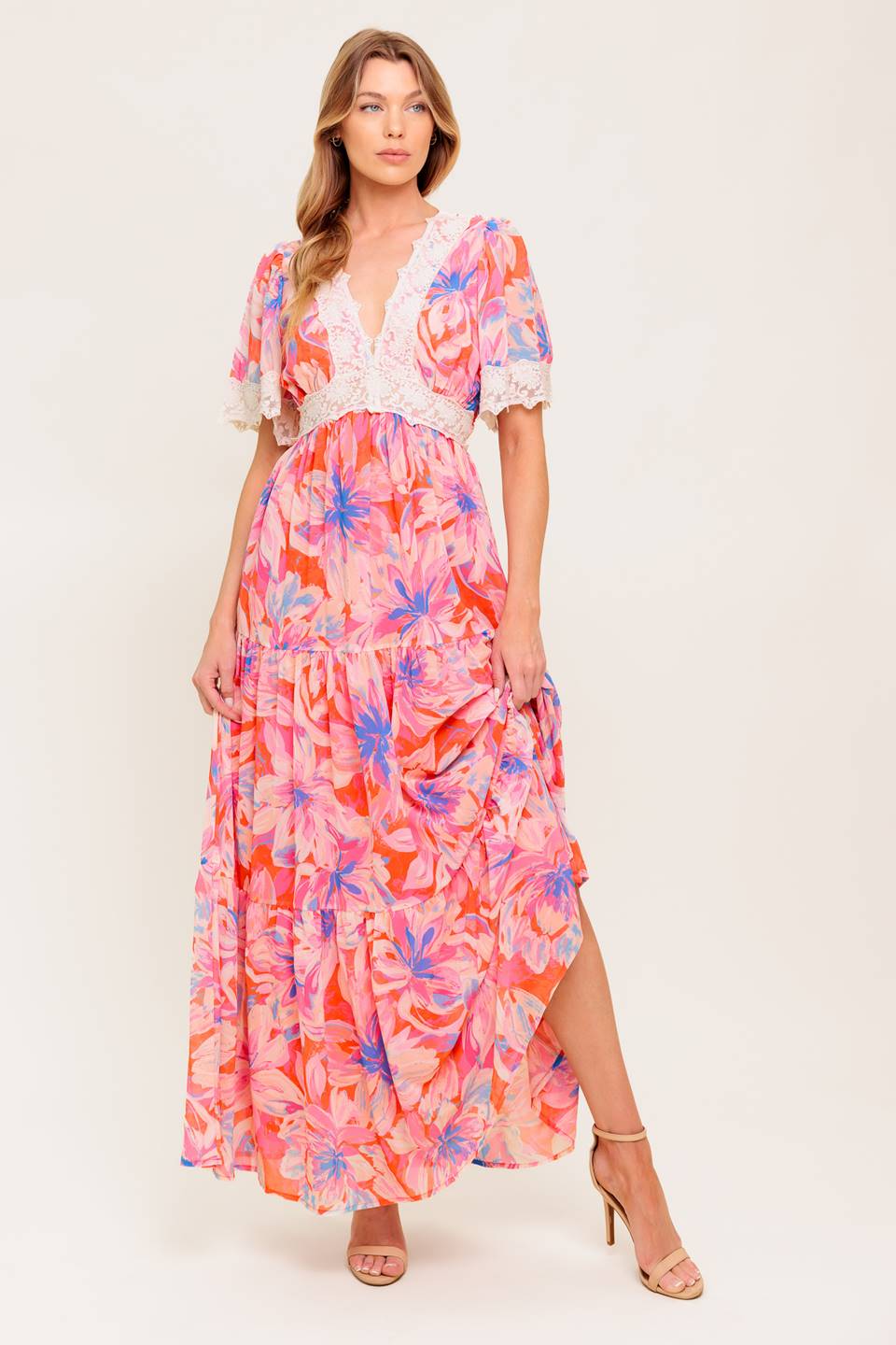 A printed woven maxi dress featuring lace trimmed V neckline, short flutter sleeve with lace hem, lace waistband, tiered skirt and smocked back waistband.