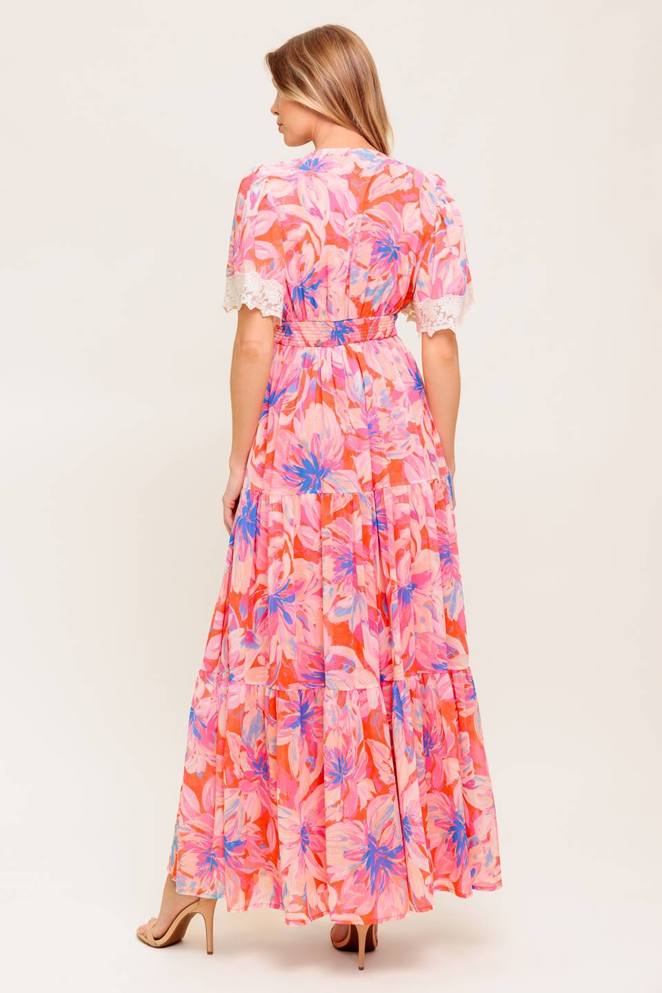 A printed woven maxi dress featuring lace trimmed V neckline, short flutter sleeve with lace hem, lace waistband, tiered skirt and smocked back waistband.