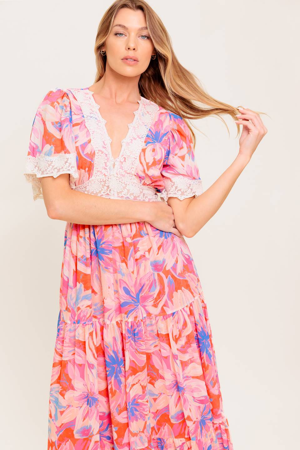 A printed woven maxi dress featuring lace trimmed V neckline, short flutter sleeve with lace hem, lace waistband, tiered skirt and smocked back waistband.