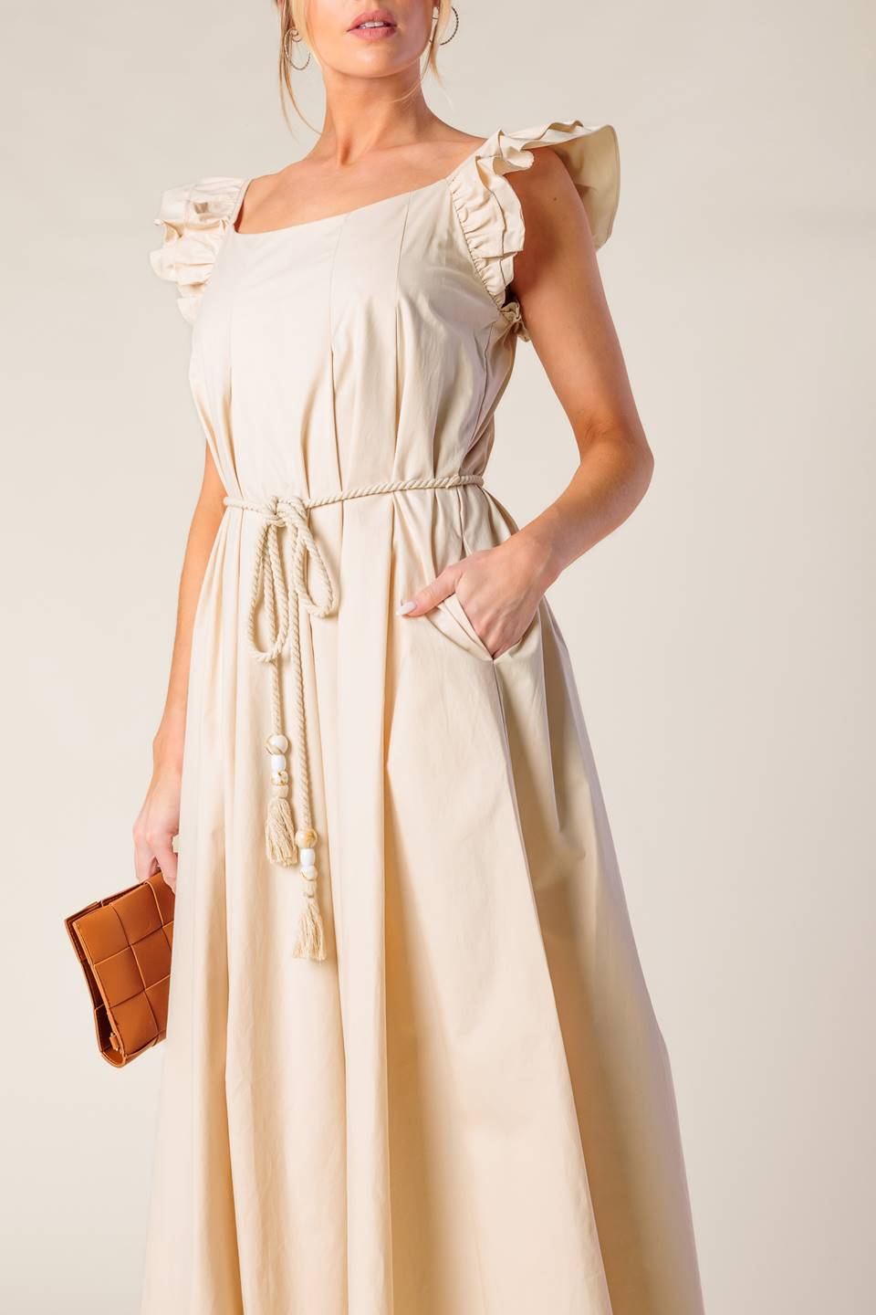 A solid woven midi dress featuring square neckline, double ruffle sleeve and rope belt