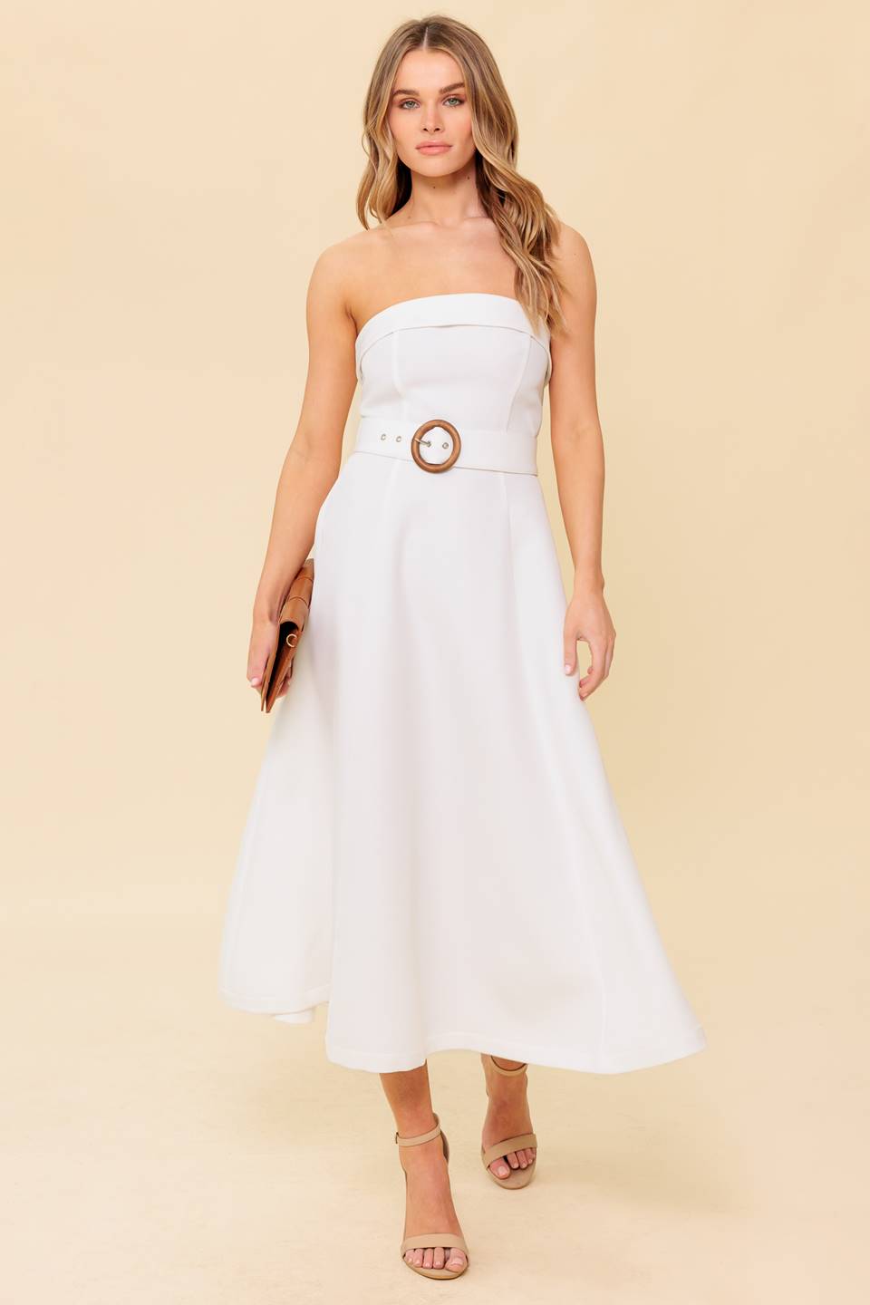 A solid woven midi dress featuring strapless, self belt, full skirt and back zipper closure