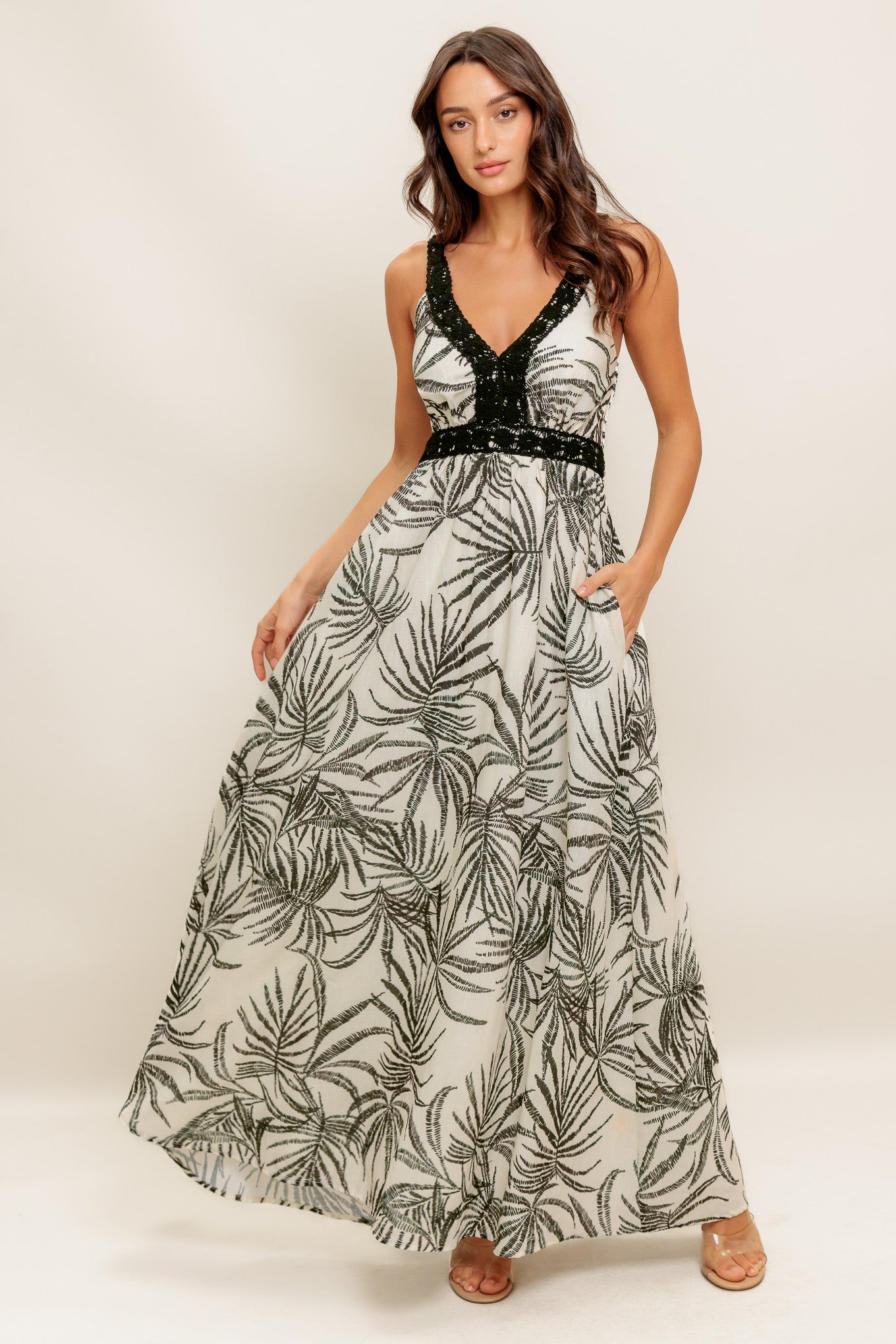A printed woven maxi dress featuring V neckline, crochet trim strap and smocked back bodice