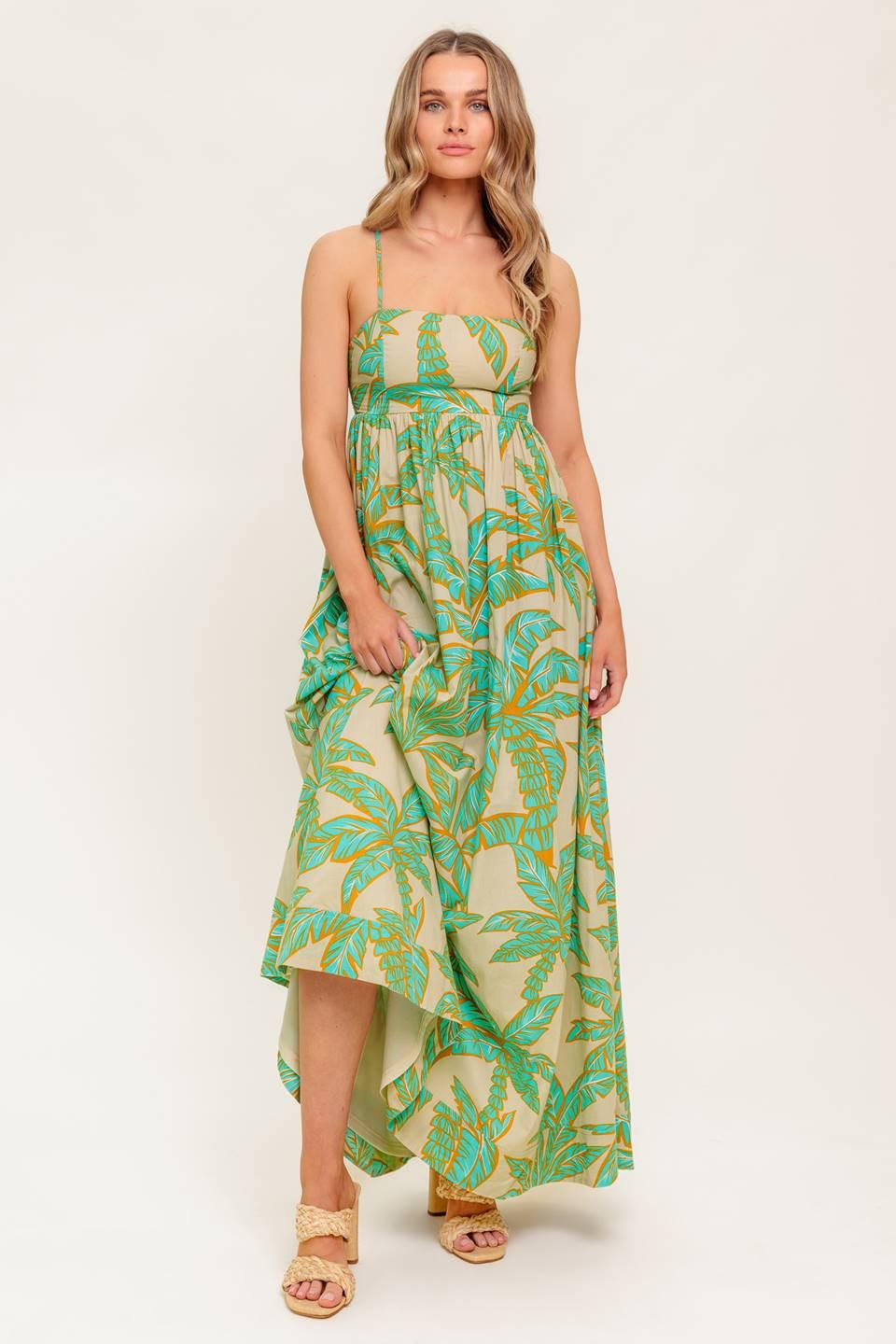 A printed woven maxi dress featuring straight neckline, straps, full skirt and bare back with smocking and tie closure.