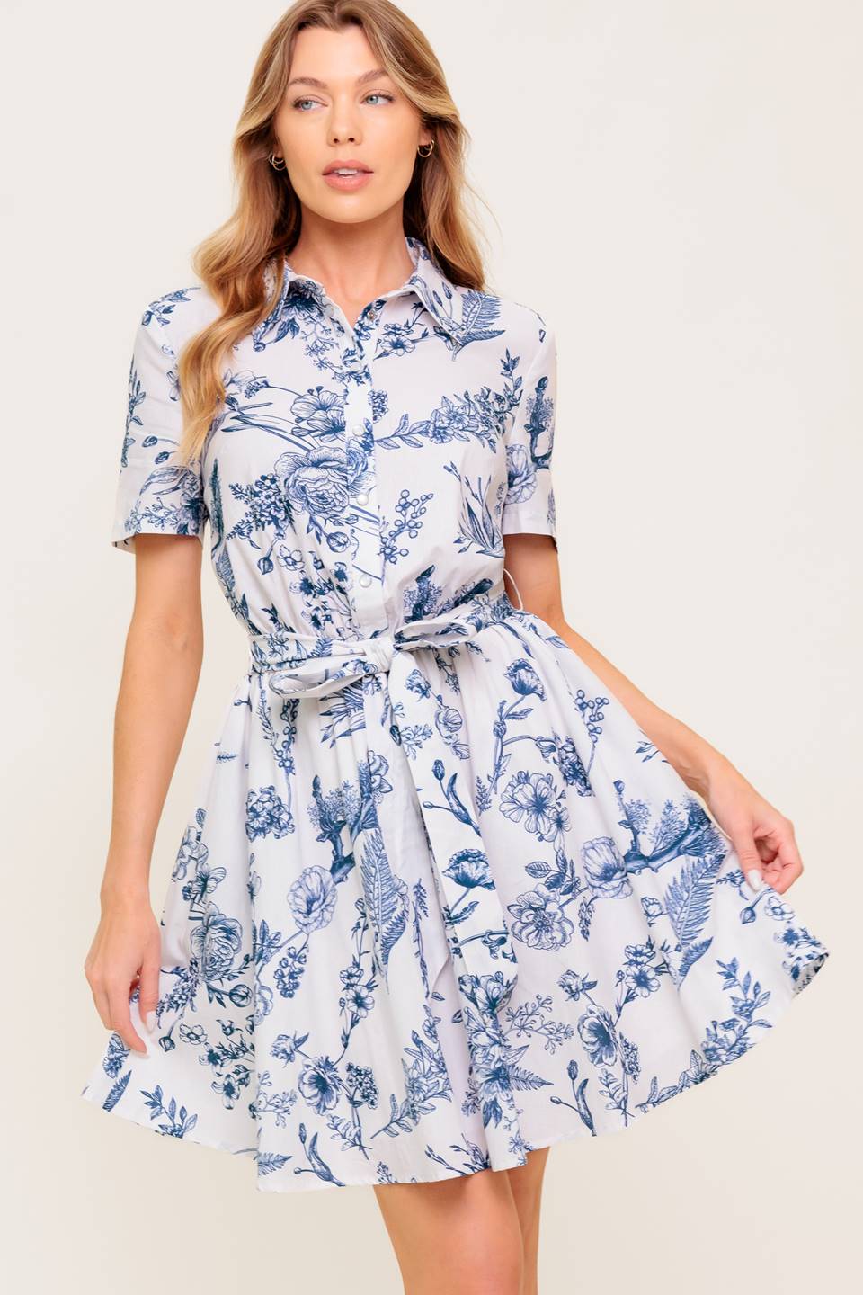 A printed woven mini shirt dress with self sash tie.