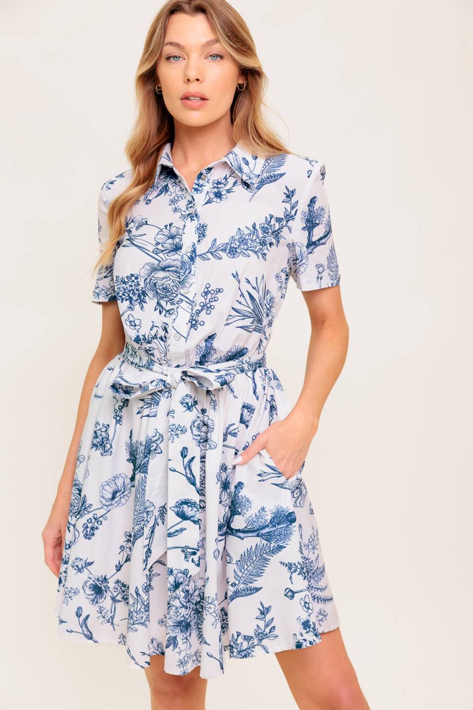 A printed woven mini shirt dress with self sash tie.