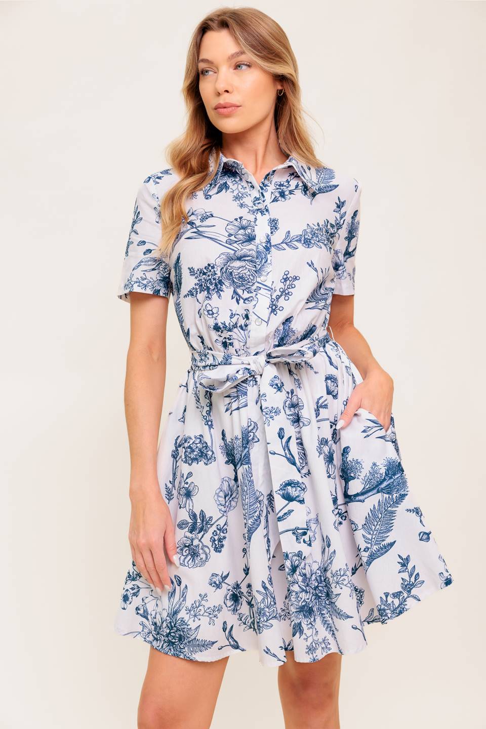 A printed woven mini shirt dress with self sash tie.