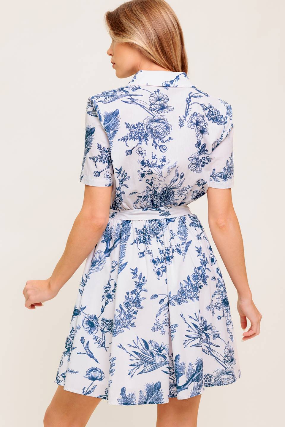 A printed woven mini shirt dress with self sash tie.