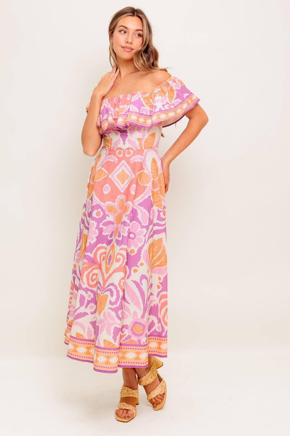 A printed woven midi dress featuring off shoulder neckline, flounce, circle skirt and back zipper closure