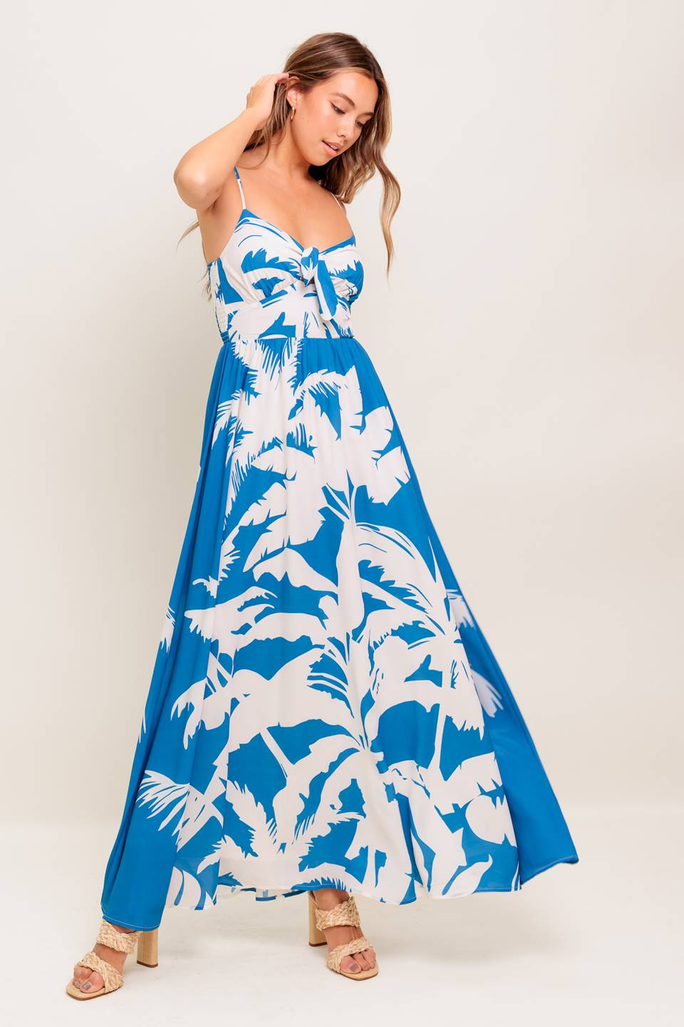 A printed woven maxi dress featuring cami top with front tie detail, straps, waist yoke and smocked back bodice