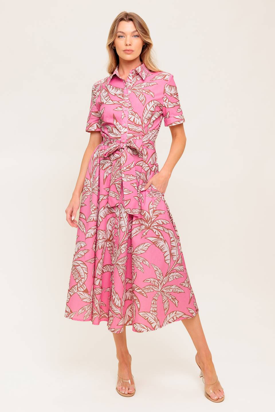 A printed woven midi dress featuring collar, short cuffed sleeve, front button down, self sash tie and full skirt.
