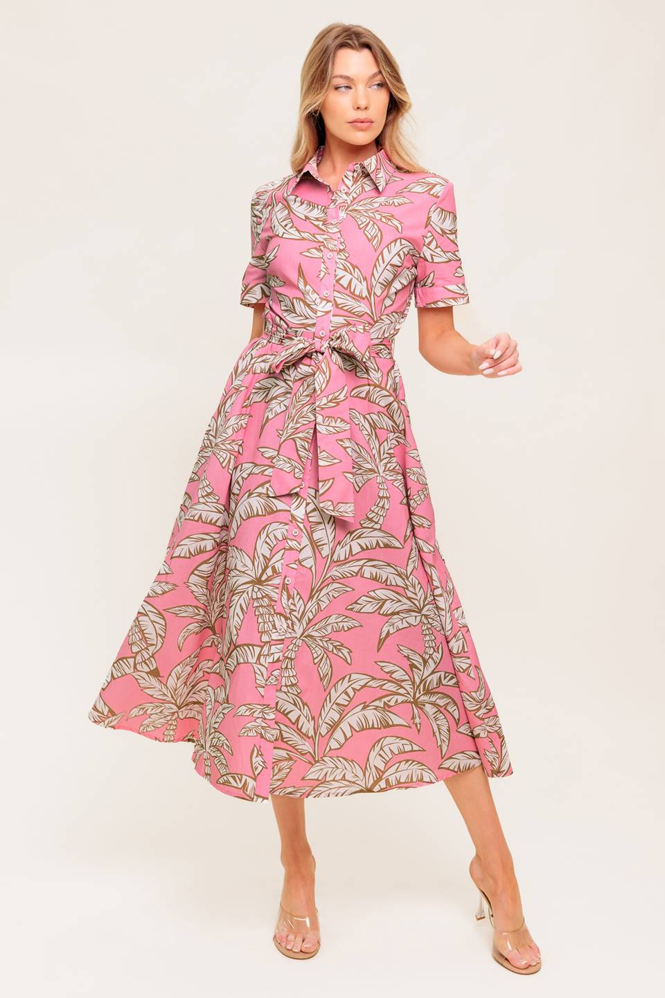 A printed woven midi dress featuring collar, short cuffed sleeve, front button down, self sash tie and full skirt.