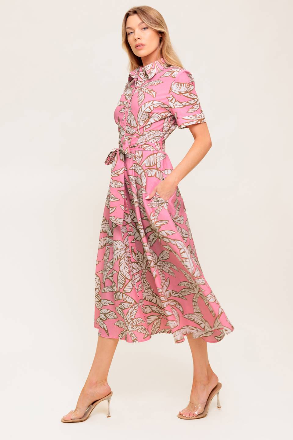 A printed woven midi dress featuring collar, short cuffed sleeve, front button down, self sash tie and full skirt.