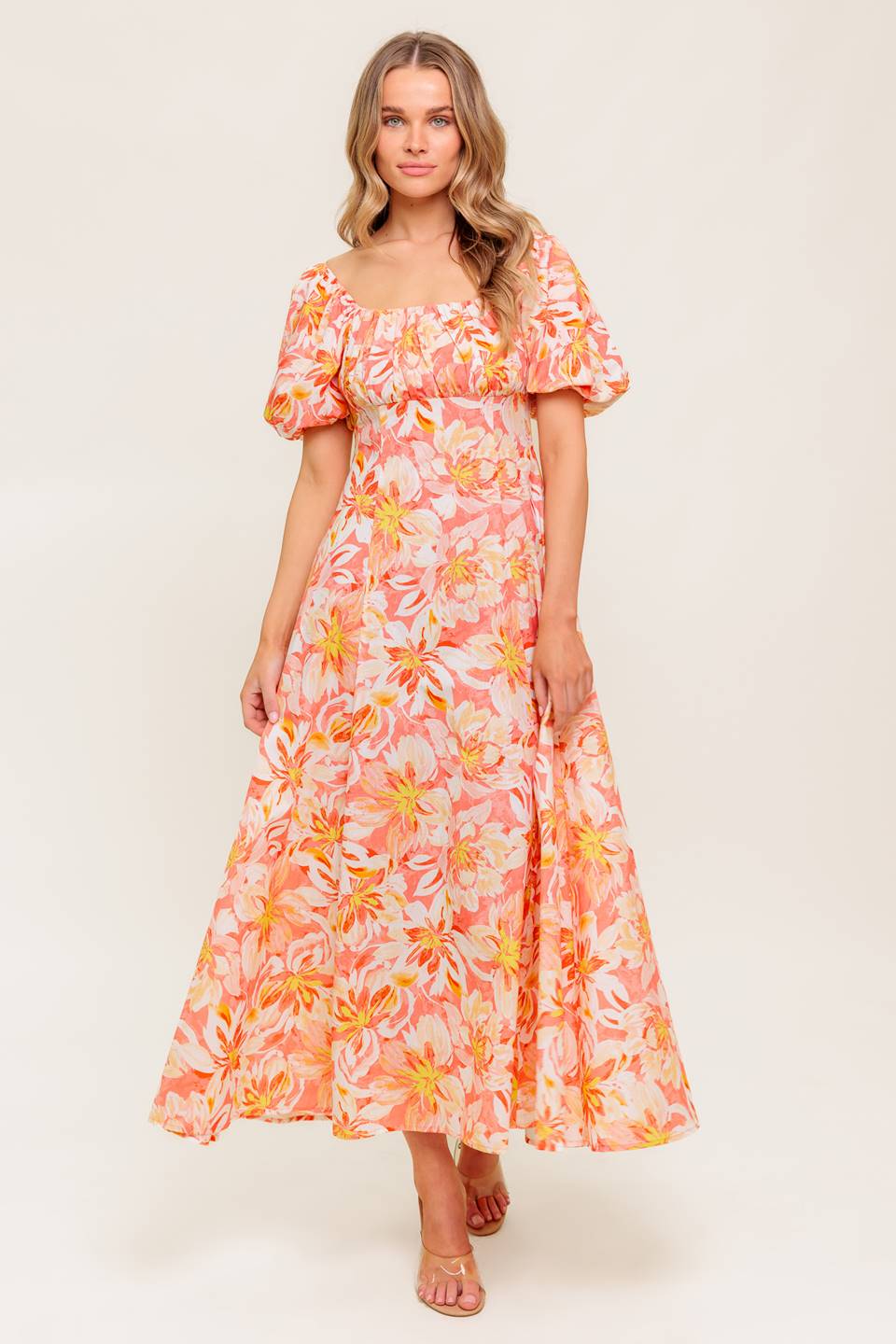 A printed woven midi dress featuring square neckline, short puff sleeve, shirred bodice, circle skirt and back zipper closure