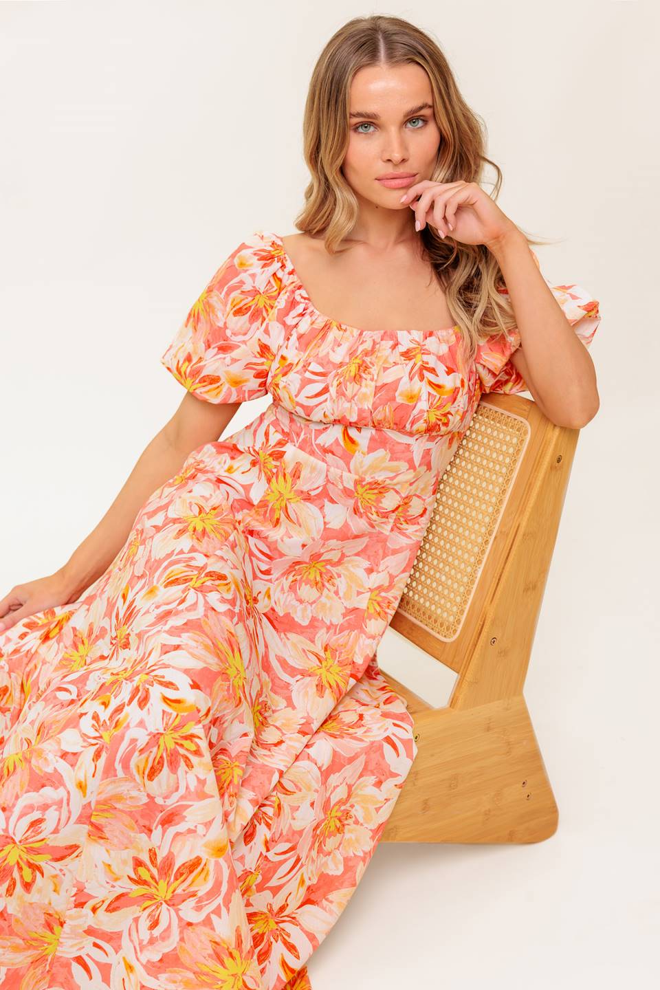 A printed woven midi dress featuring square neckline, short puff sleeve, shirred bodice, circle skirt and back zipper closure