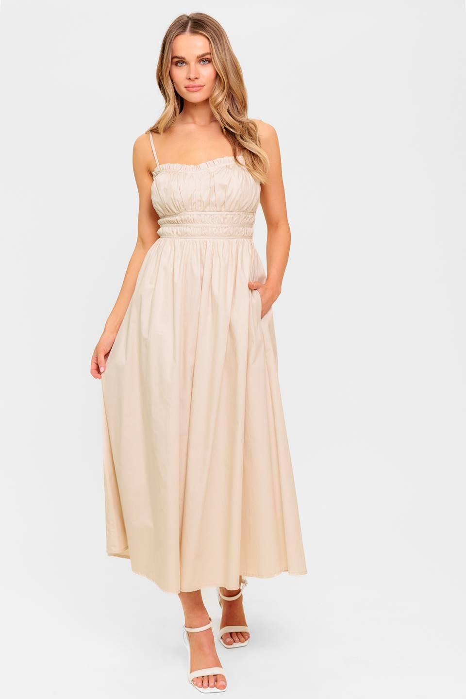 A solid woven midi dress featuring sweetheart neckline, straps, shirred bodice, elasticized back, side pocket and full skirt.