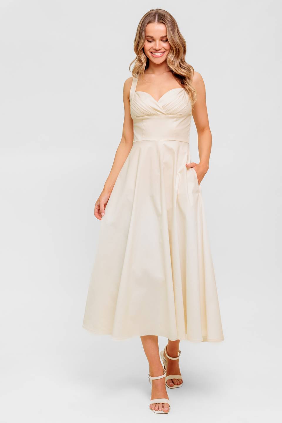 A printed woven midi dress featuring strapless, shirred bodice, full skirt and smock and zipper back closure.