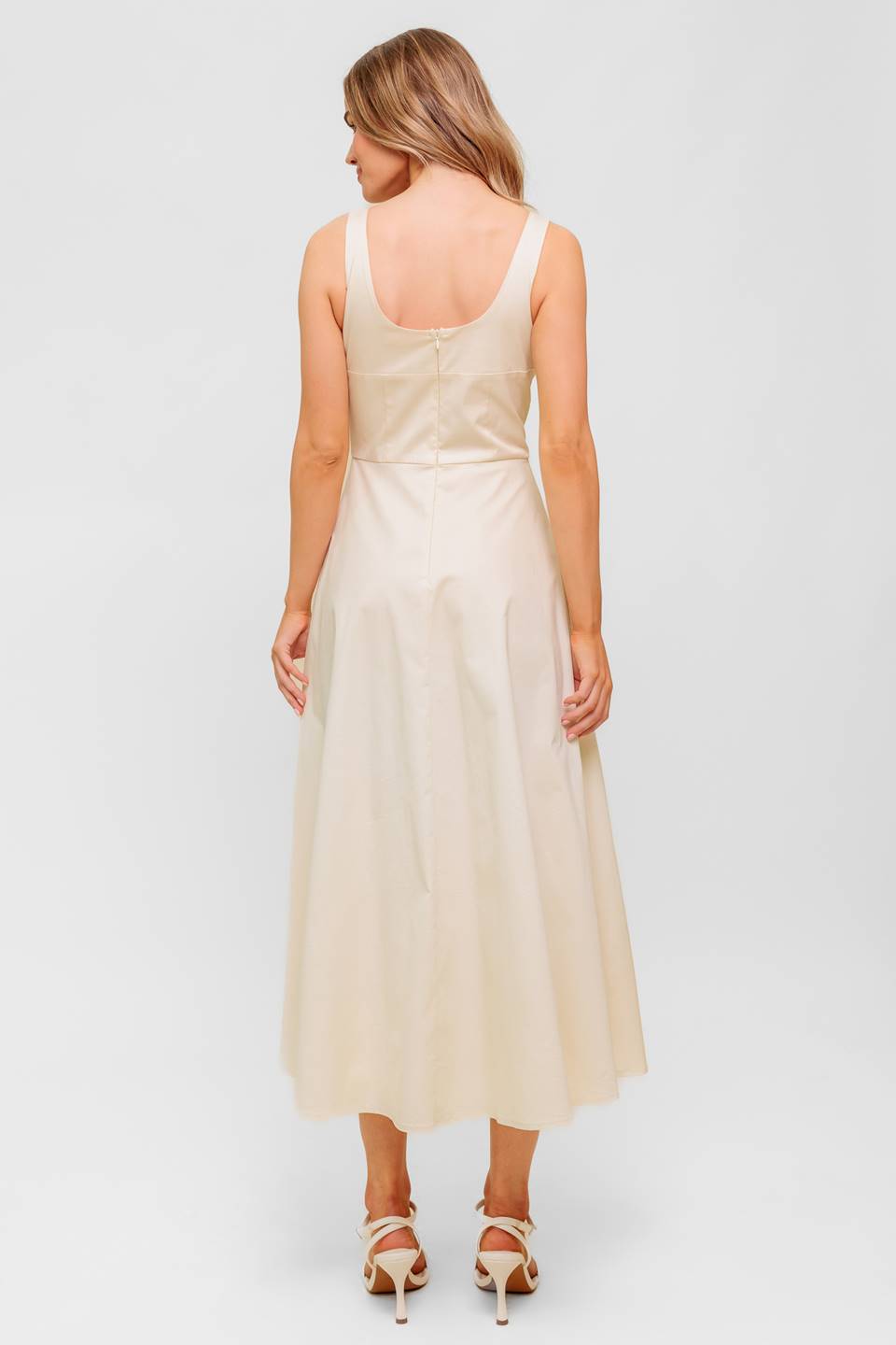 A printed woven midi dress featuring strapless, shirred bodice, full skirt and smock and zipper back closure.