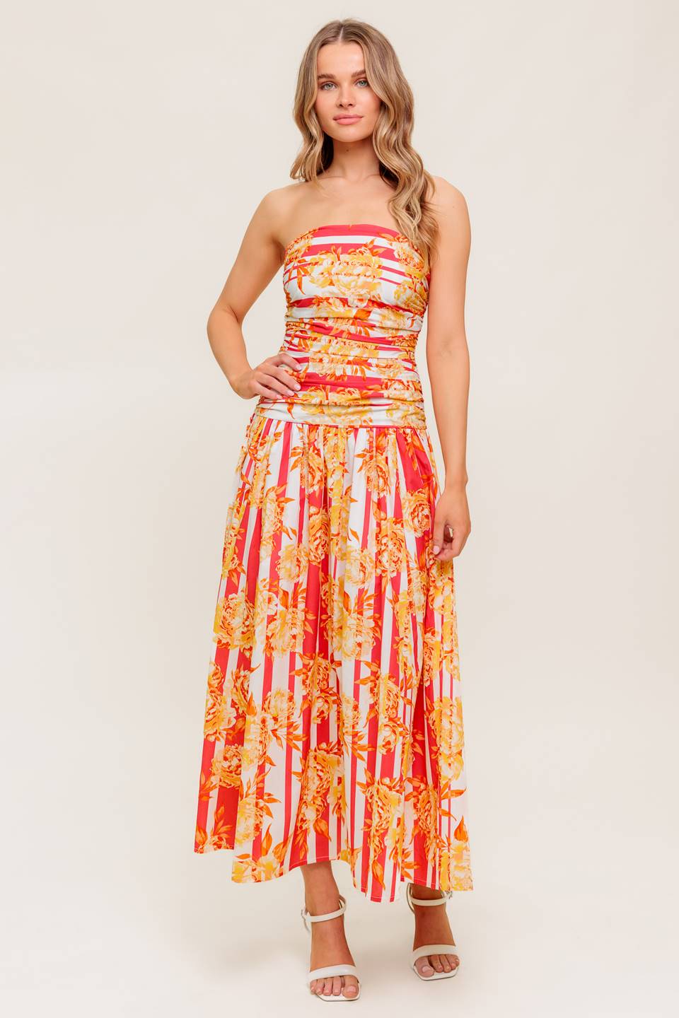 A printed woven midi dress featuring strapless, shirred bodice, full skirt and smock and zipper back closure