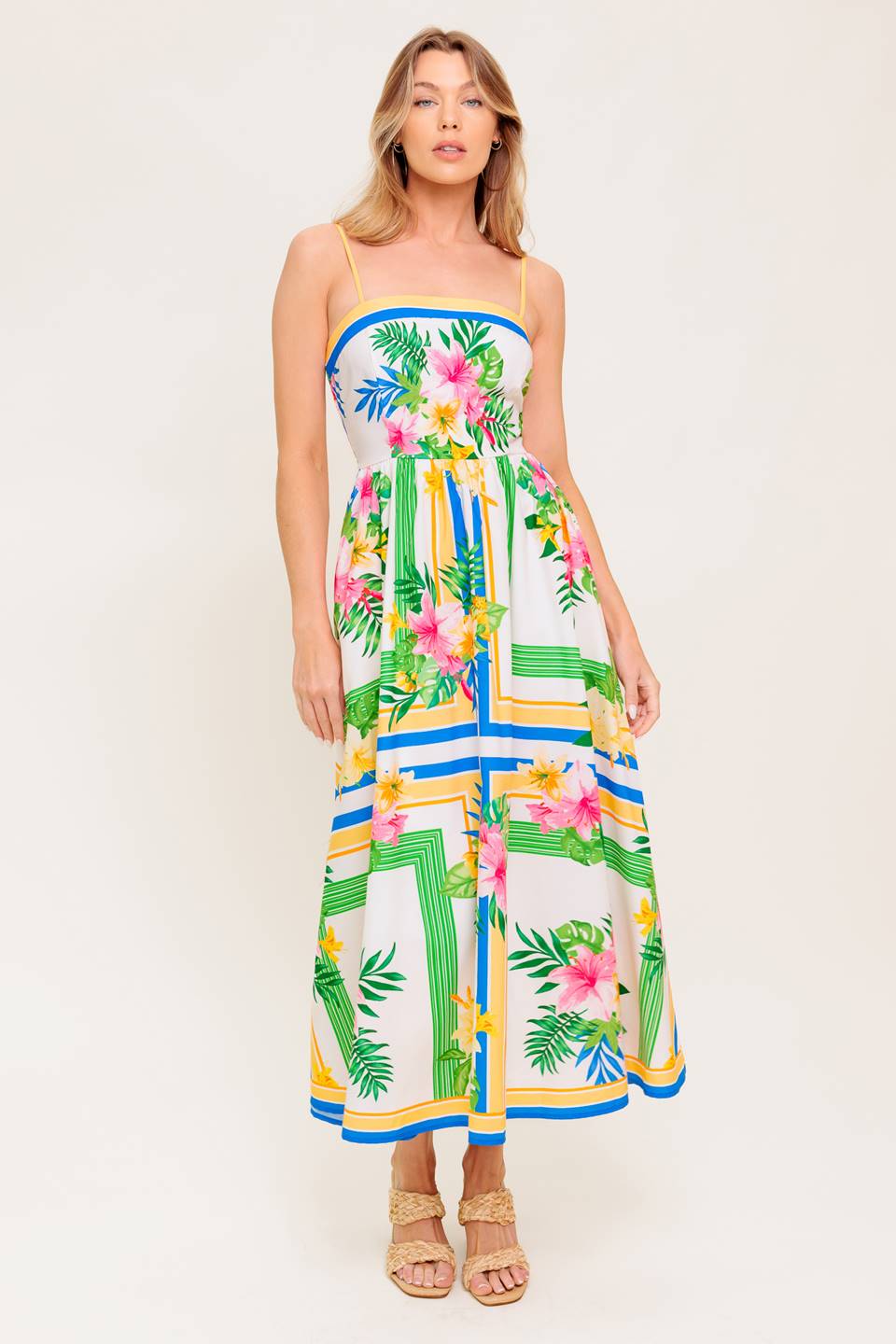 A printed woven midi dress featuring straight neckline, straps, full skirt and smocked back bodice.