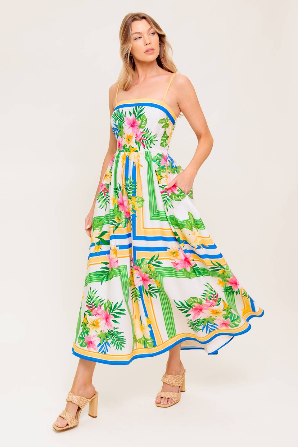 A printed woven midi dress featuring straight neckline, straps, full skirt and smocked back bodice.
