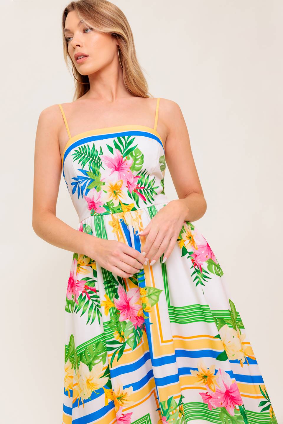 A printed woven midi dress featuring straight neckline, straps, full skirt and smocked back bodice.
