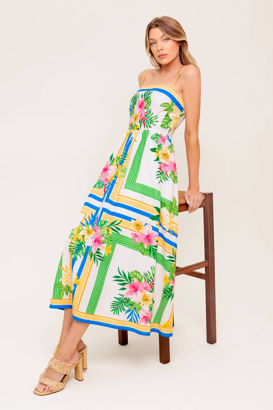 A printed woven midi dress featuring straight neckline, straps, full skirt and smocked back bodice.
