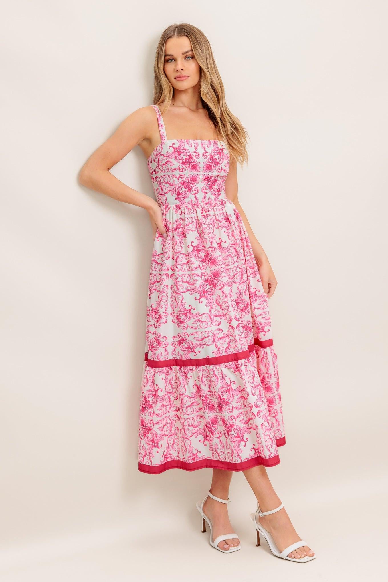 A printed woven midi dress featuring straight neckline, straps, ruffle hemline and smocked back bodice