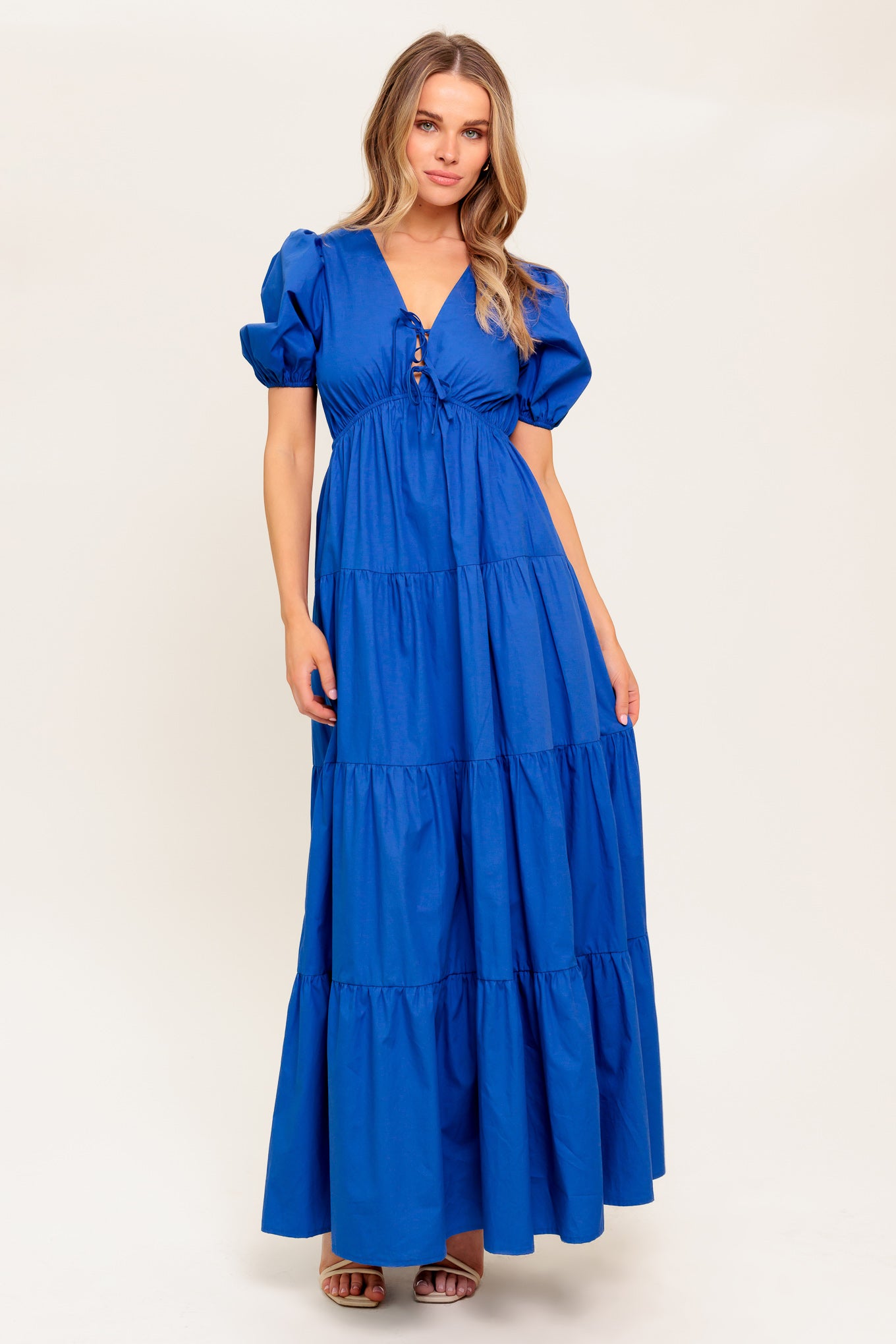 A solid royal blue woven maxi dress featuring V neckline with front bow closure, short puff sleeve, elasticized empire and tiered skirt.
Details:
Self : 100% Cotton
Size & Fit
- Model is 5`8" And Wearing Size Small
- Measurements Taken From Size Small
- Approx. Length: 59" Flying Tomato