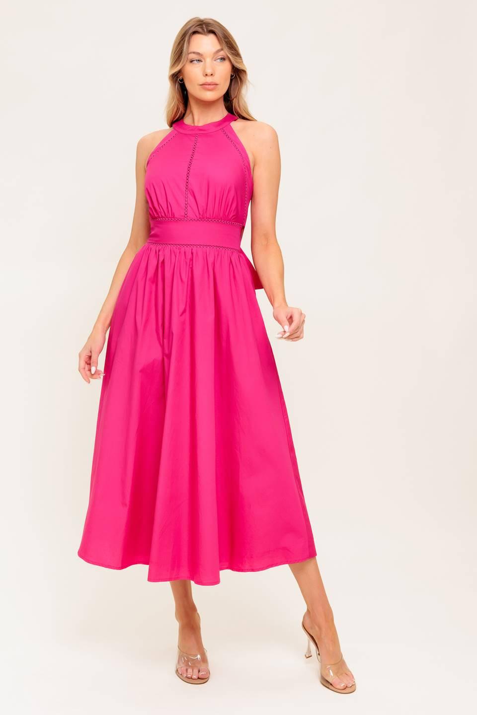 A solid hot pink woven midi dress featuring halter neckline, lace inset detail, smocked back waistband and bare back with button/tie closure.