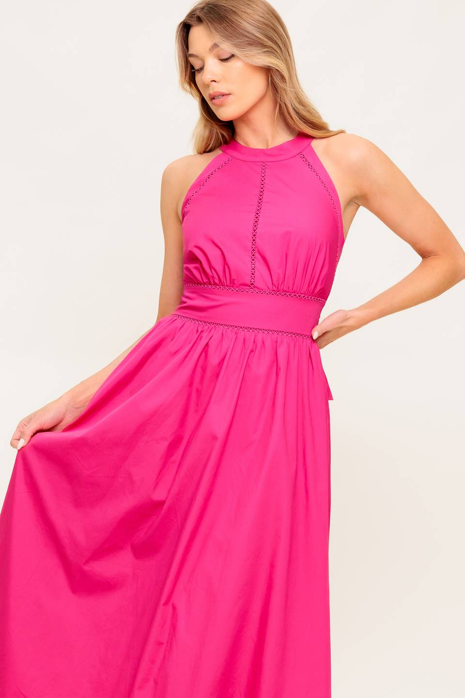 A solid hot pink woven midi dress featuring halter neckline, lace inset detail, smocked back waistband and bare back with button/tie closure.